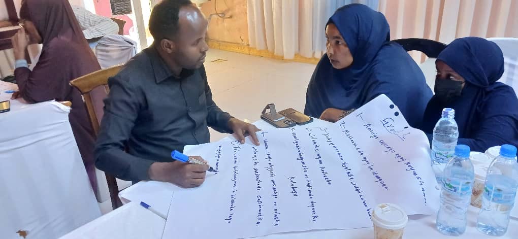 Community group discussion on land and property disputes at an APCO peacebuilding session